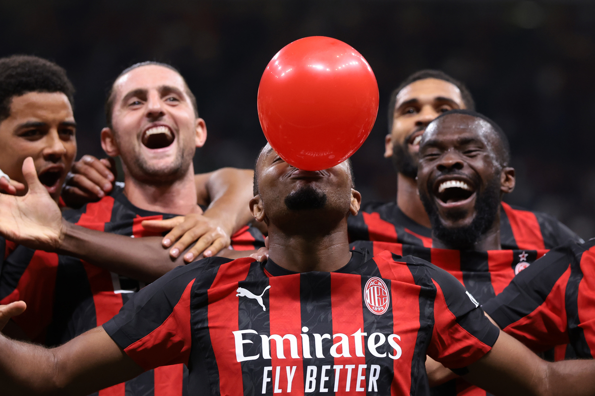 MILAN, ITALY - SEPTEMBER 23: Christopher Nkunku of AC Milan inflates a balloon as he celebrates with teammates after scoring to give the side a 2-0 lead during the Coppa Italia Frecciarossa Round of 16 match between AC Milan and US Lecce at Giuseppe Meazza Stadium on September 23, 2025 in Milan, Italy. (Photo by Jonathan Moscrop/Getty Images)